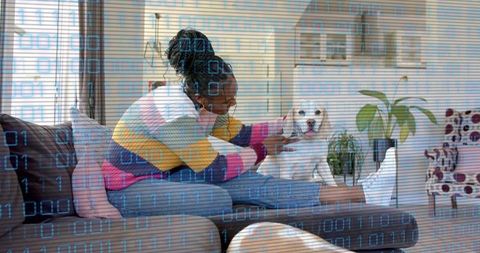 Woman Relaxing with Puppy in Cozy Living Room with Digital Overlay