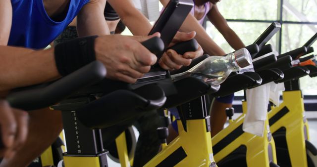 Group Cycling Class Working Out Using Stationary Bikes Indoors - Download Free Stock Images Pikwizard.com