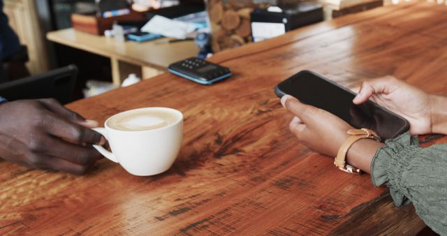 People Enjoying Coffee While Using Smartphone at Coffee Shop - Download Free Stock Images Pikwizard.com