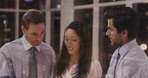 Business Team Engaged in Financial Analysis with Digital Graphs Overlay