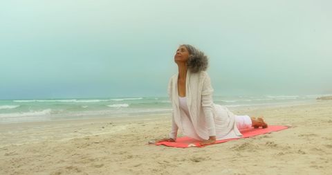 Senior African American Woman Practicing Yoga at Beach in Sea Breeze - Download Free Stock Images Pikwizard.com