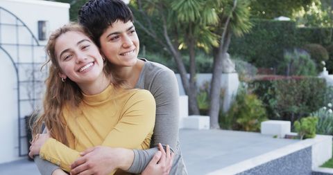 Joyful Lesbian Couple Embracing Outside Modern Home - Download Free Stock Images Pikwizard.com