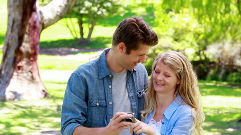 Happy Couple Capturing Moments in Lush Green Park