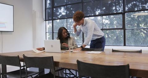 Diverse Colleagues Collaborating on Corporate Project Using Technology