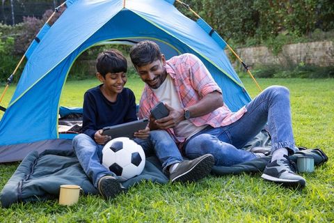 Father and Son Camping Bonding with Technology