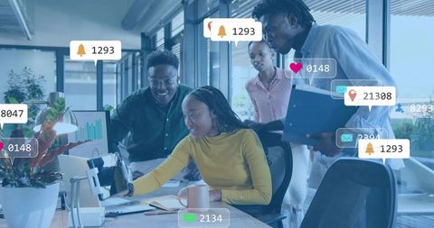 Team Collaborating at Desk with Social Media Notifications Overlay in Open-Plan Office