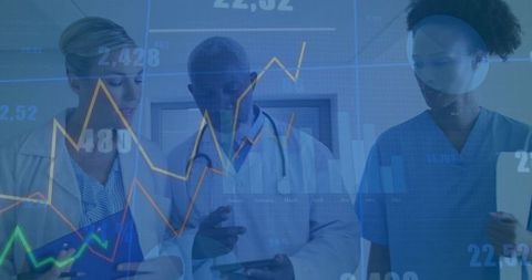 Medical team analyzing data with digital technology in clinical hallway