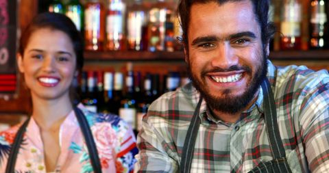 Cheerful Bartenders in Lively Pub Environment