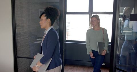 Diverse Professionals Walking into Modern Conference Room