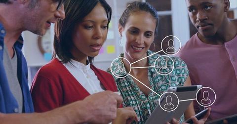 Diverse Team Examining Digital Network on Tablet in Collaborative Workspace