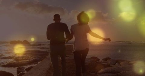 Couple Running on Rocky Beach at Sunset - Download Free Stock Images Pikwizard.com