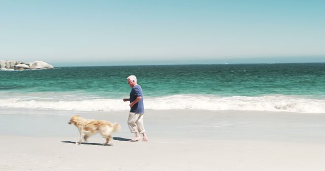 Old retired man running with dog on the beach