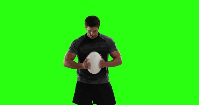 Rugby player holding ball on green screen background, ready for any action or advertisement. Perfect for sports-related promotions, fitness and training campaigns, and athletic apparel advertisements.
