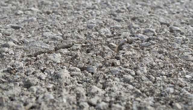 Crushed gravel ground texture with small stones and pebbles close-up for backgrounds
