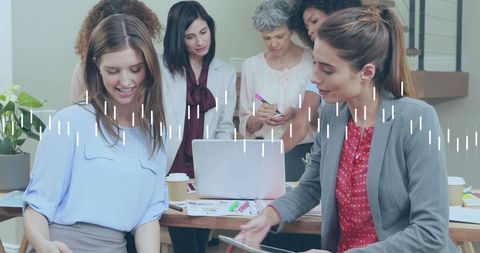 Diverse Business Team Analyzing Financial Data on Laptops