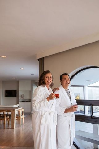 Senior couple relaxing in luxury suite with refreshing drinks