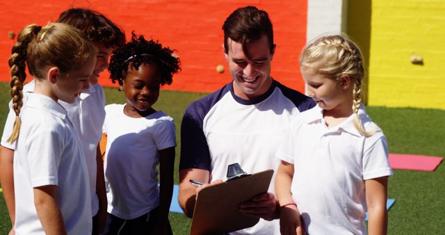 Coach Engaging with Smiling Children during Outdoor Sports Activity - Download Free Stock Images Pikwizard.com