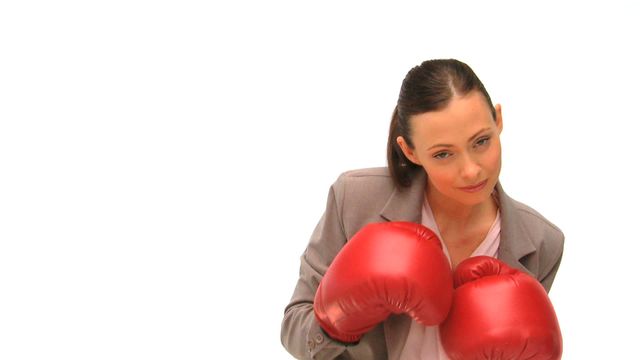 Video depicts a professional young woman in boxing gloves, symbolizing determination, strength, and competitiveness. Ideal for business-related presentations, motivational materials, articles on women's empowerment, leadership training content, or corporate strength messaging.