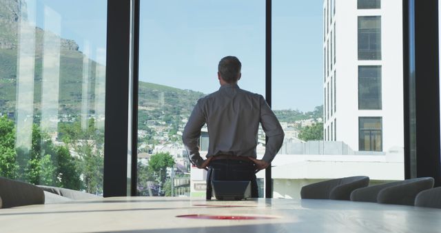 Businessman Looking Out Office Window - Download Free Stock Images Pikwizard.com