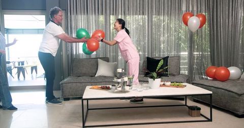 Nurse and Patients Joyfully Decorating Therapy Room