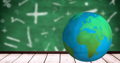 Spinning earth globe with math symbols on green chalkboard background