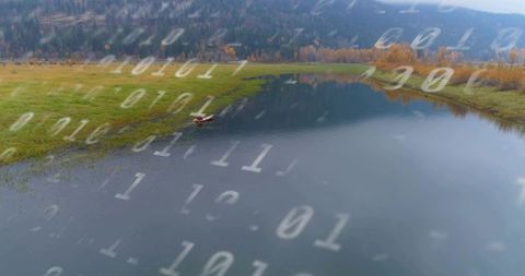 Paddling red canoe on autumn lake with binary data overlay for tech-nature concept