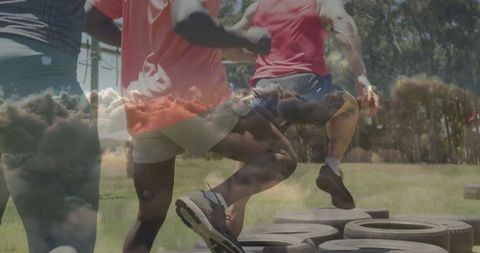 Athletes performing agility drill on tires in park