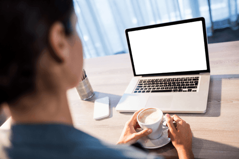 Woman Holding Coffee Cup at Transparent Screened Laptop on Desk - Download Free Stock Videos Pikwizard.com