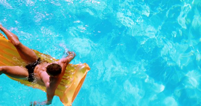 Man relaxing on inflatable float in clear swimming pool - Download Free Stock Images Pikwizard.com