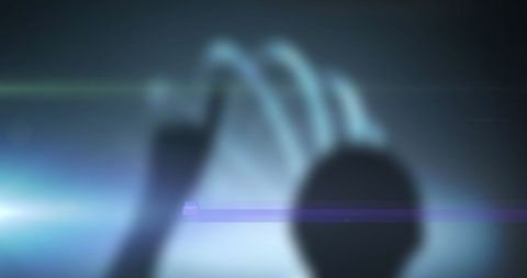 Silhouette Touching Futuristic Digital Interface with Glow