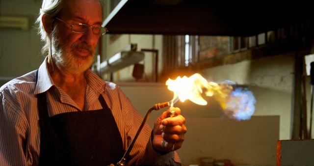 Senior Craftsman Using Blowtorch in Workshop - Download Free Stock Images Pikwizard.com