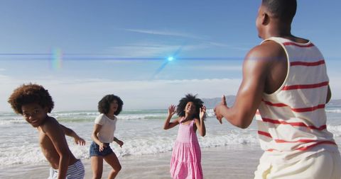 Vibrant African American Family Playing at Sunny Beach