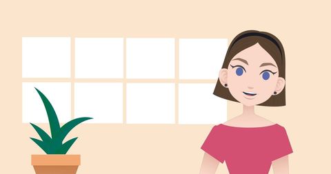 Smiling woman indoors with potted plant and decorative background