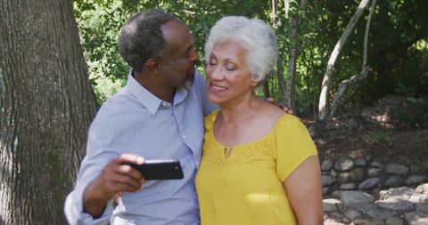 Senior Couple Sharing Joyful Moment Taking Outdoor Selfie