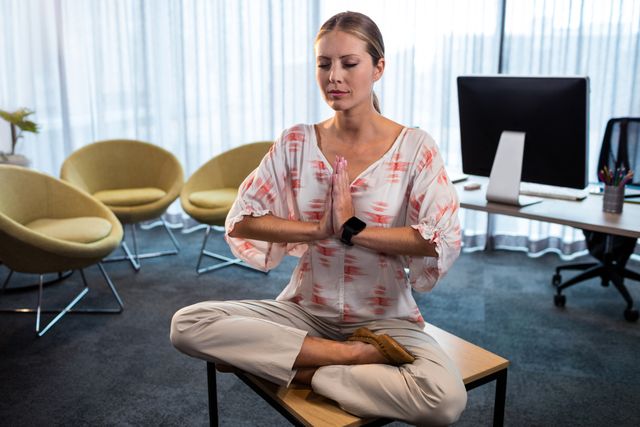 Businesswoman Practicing Yoga on Office Desk - Download Free Stock Photos Pikwizard.com
