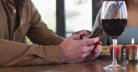 Couple Enjoying Lunch with Phone at Cozy Restaurant Table - Download Free Stock Images Pikwizard.com