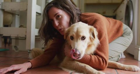 Woman Hugging Tan Dog in Cozy Laundry Room Setting