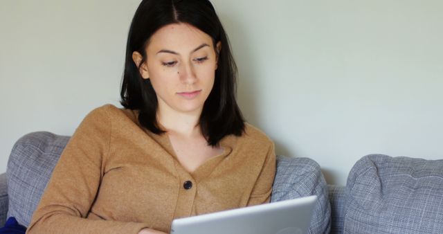 Young Woman Relaxing with Tablet on Couch at Home - Download Free Stock Images Pikwizard.com