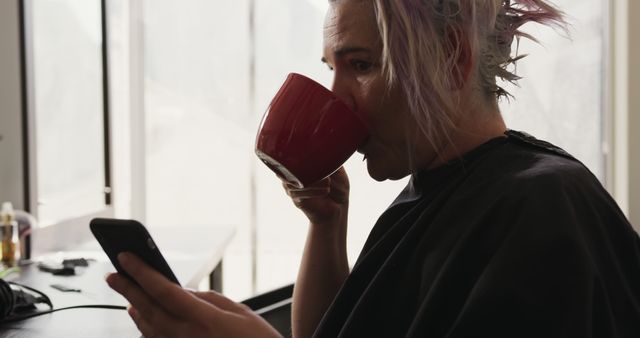 Person with Stylish Hair Drinking Coffee and Using Smartphone - Download Free Stock Images Pikwizard.com