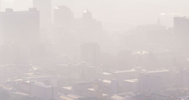 This scene showcases a modern urban landscape shrouded in thick atmospheric haze, highlighting concerns about air quality and environmental pollution. Ideal for articles on climate change, environmental health, cityscape prints, and urban planning. Use this for creating awareness about urban pollution and for visual illustrations in environmental campaigns.