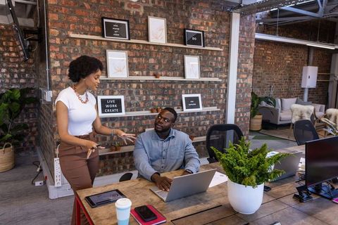 Diverse Coworkers Collaborating in Modern Industrial Workspace