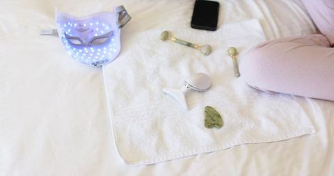 At-home led facial mask and jade roller skincare routine with gua sha and massager