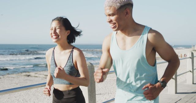 Fit Young Couple Running Along Beachside Promenade on Sunny Day - Download Free Stock Images Pikwizard.com