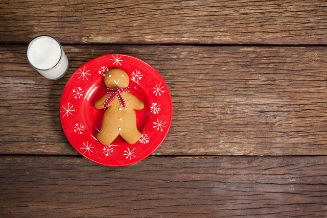 Ginger bread and milk on wooden table during christmas time