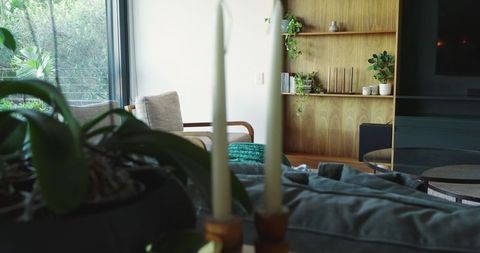 Modern living room interior with candles and wooden accents
