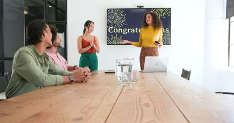 Office celebration meeting with team applause and congratulations