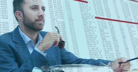 Contemplative businessman with pipe studying projected spreadsheet data for analytics