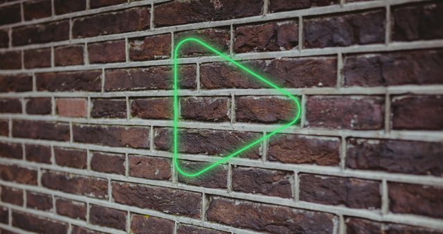 Illuminated Digital Green Play Button Icon Against Brick Wall - Download Free Stock Images Pikwizard.com