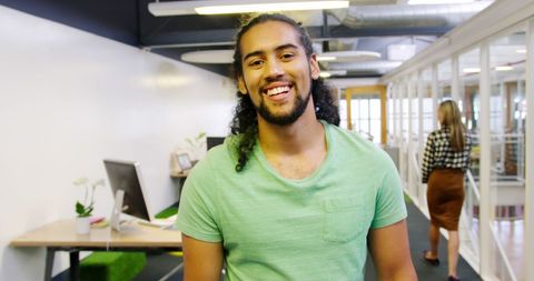 Casual office with happy young biracial professional smiling