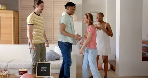 Friends Celebrating New Job in Cozy Living Room